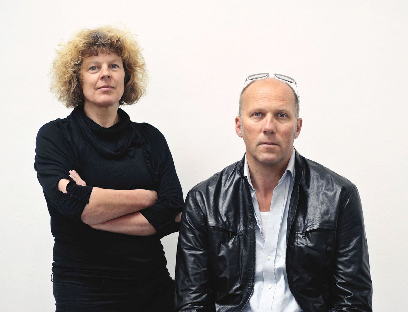 A man and a woman standing against a white background
