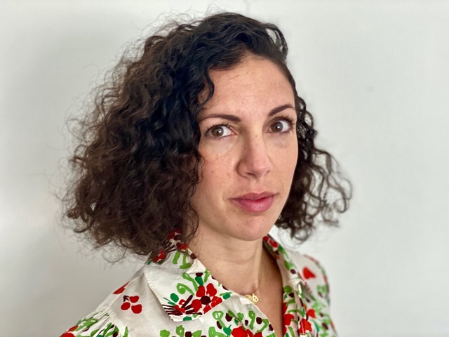 A portrait of a lady wearing a floral shirt